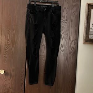 Torrid black jeans with torn holes along the front legs. Skinny jeans. Size 10S